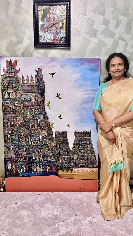 Anudeepa Kadiresan standing beside her large Srirangam Gopuram canvas