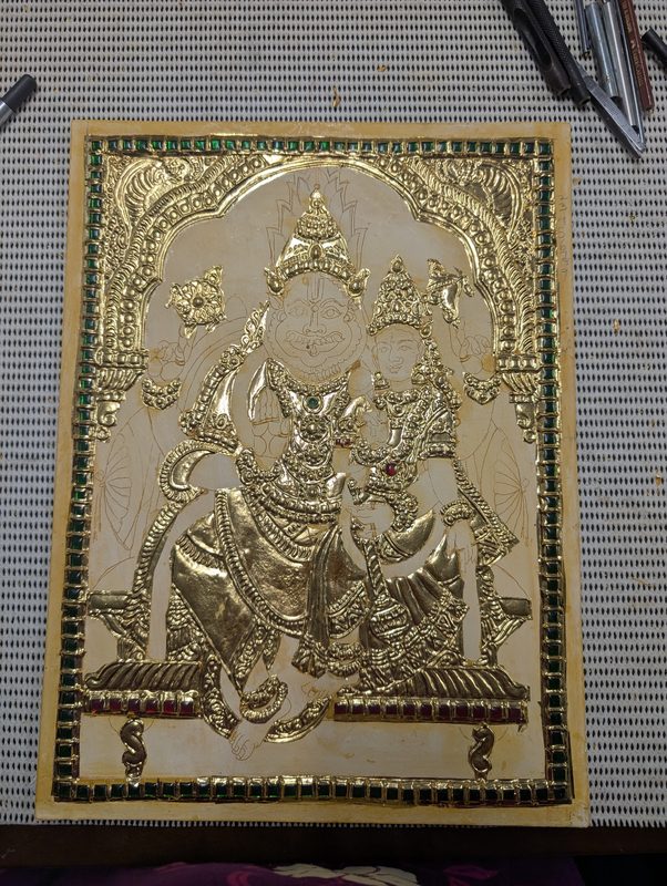 The relief work covered in shining gold foil