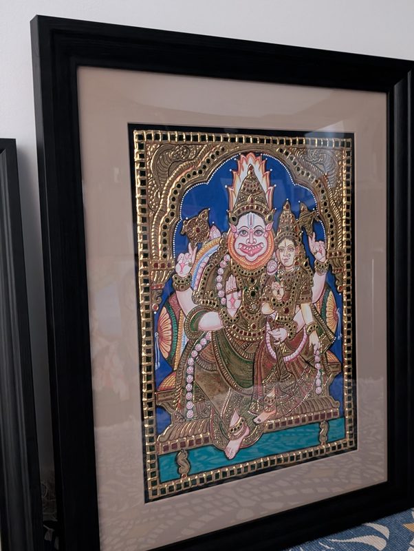 The Lakshmi Narasimhar painting in a dark wooden frame