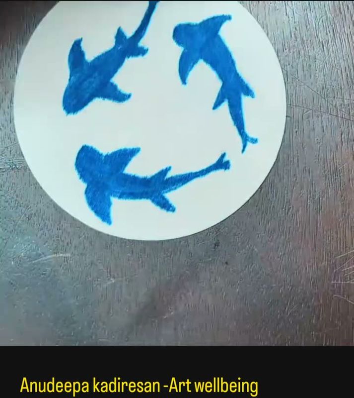Blue fish painted on a white disc