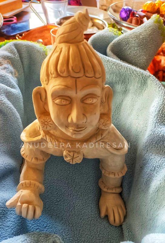 Clay sculpture of baby Krishna crawling