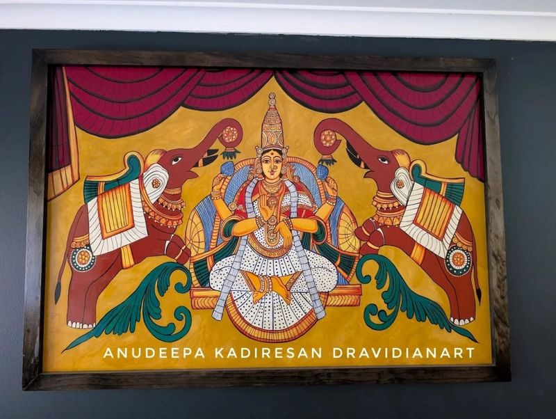 Framed painting of a goddess seated between two elephants