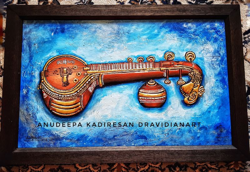 Relief artwork of a veena on a blue background
